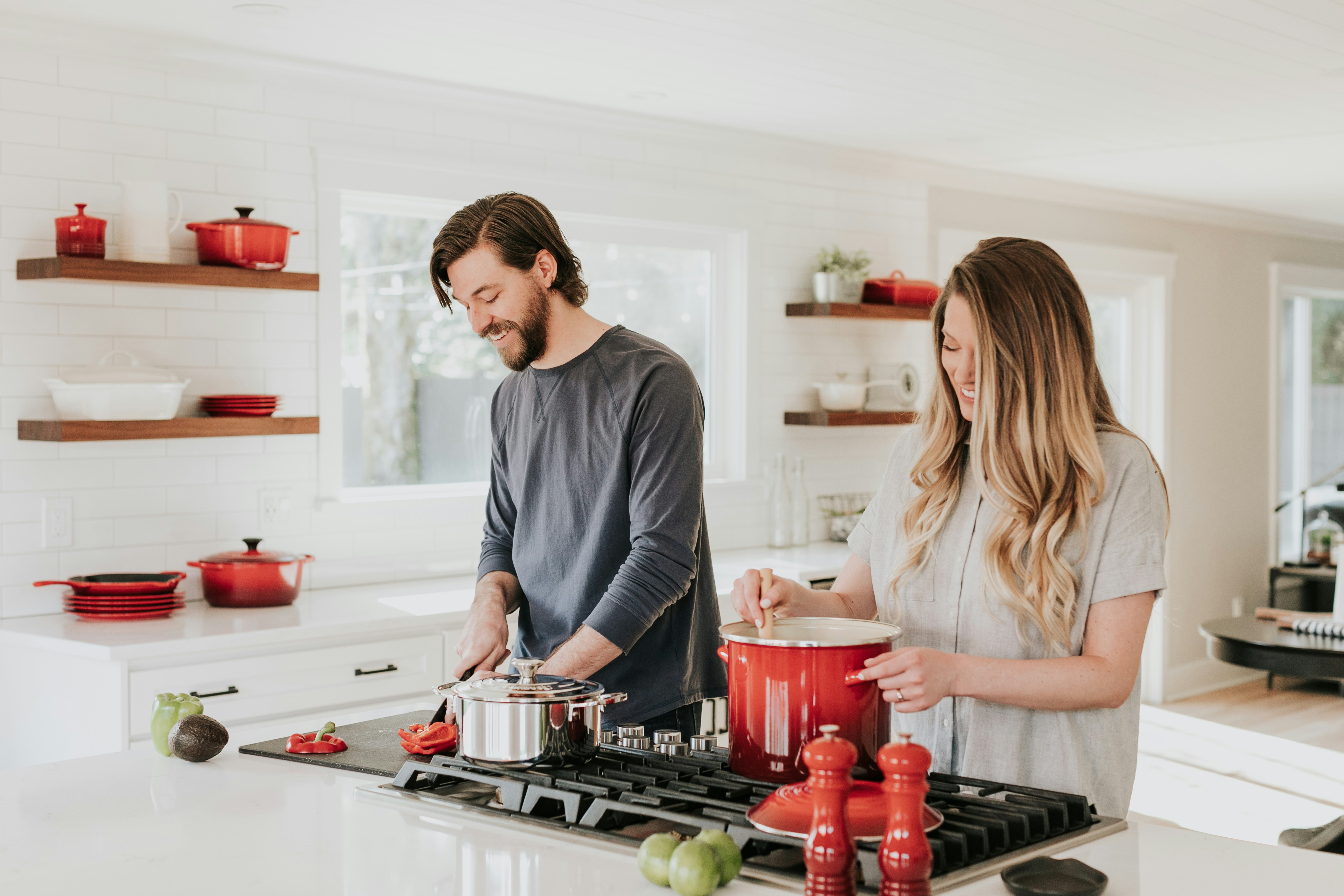 Smiling couple cooking together in a bright family kitchen