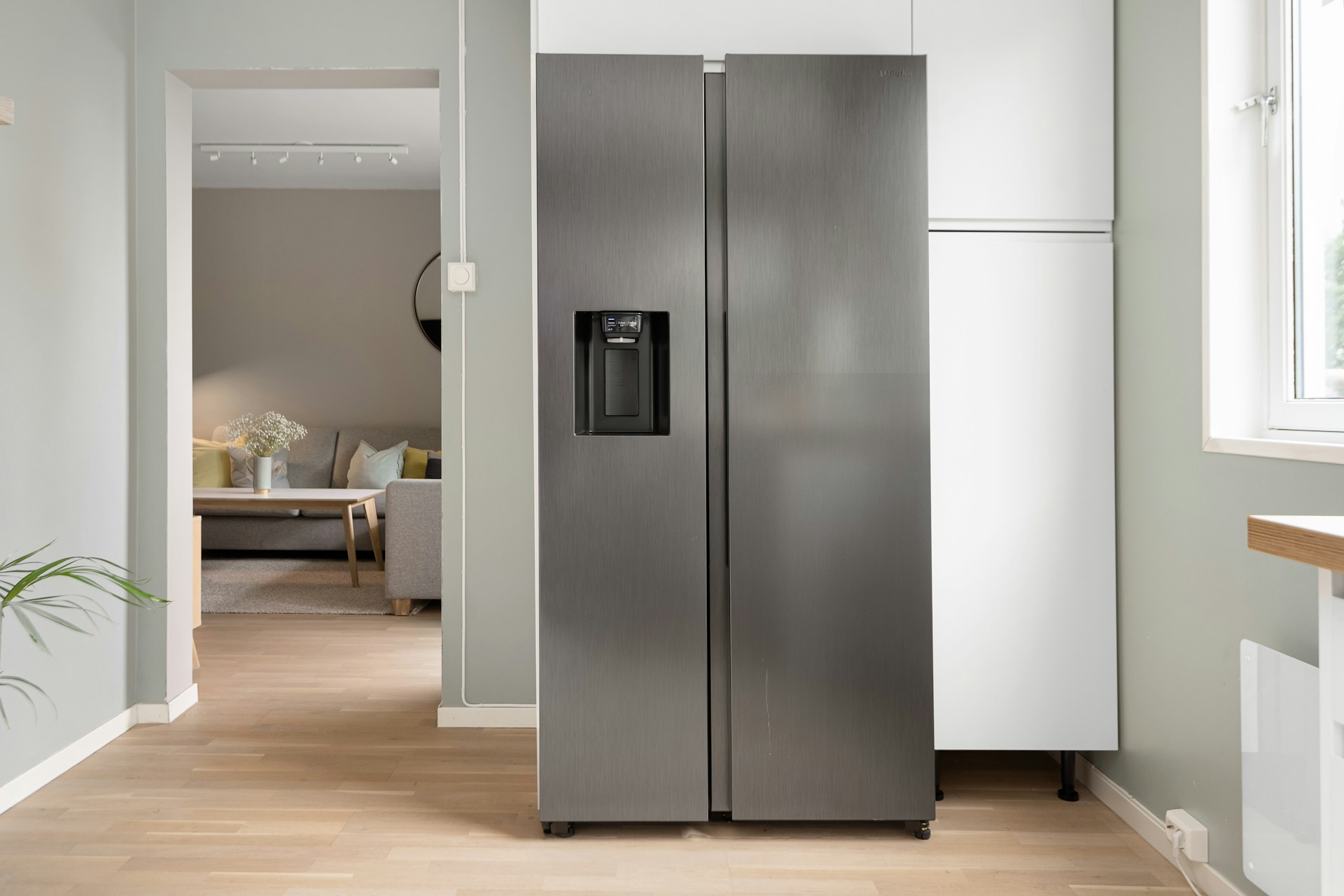 Premium stainless steel refrigerator in a bright residential interior